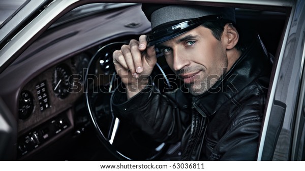 Chauffeur sitting in the\
car