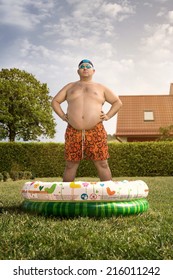Cheap holidays at home, funny overweight man about to swim in the back yard pool