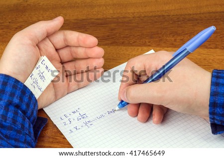 cheat sheet written in the hand a schoolboy, student
