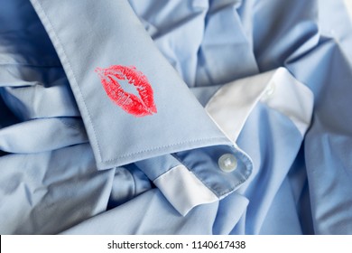 Cheating Husband/boyfriend Concept: Red Lips Print On A Collar Of A Blue Shirt