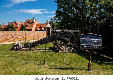 Cheb, Western Bohemia, Czech Republic, 14 August 2021: Gothic stone castle, medieval historic fortress or stronghold in sunny summer day, black Tower, old cannon near defense walls