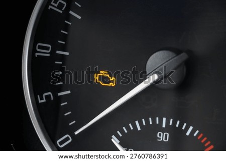 Check engine light in car closeup photo.
