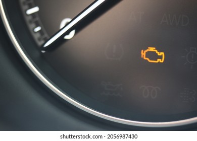 Check engine light glowing in a new car gauge
