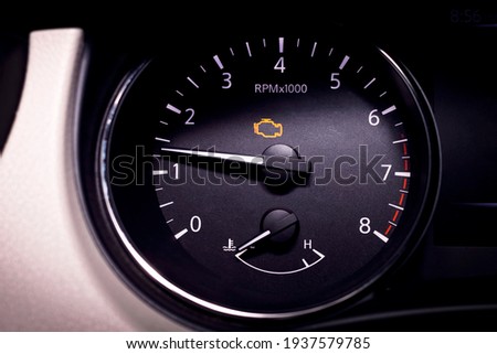Check engine light illuminated on dashboard showing rough idle condition.