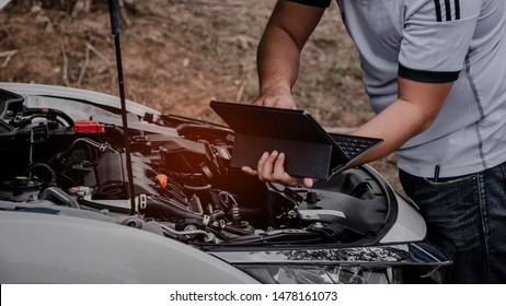 Check The Engine Room Of The Car Using A Computer.