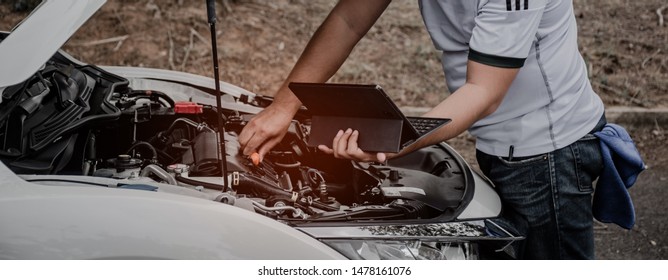 Check The Engine Room Of The Car Using A Computer.