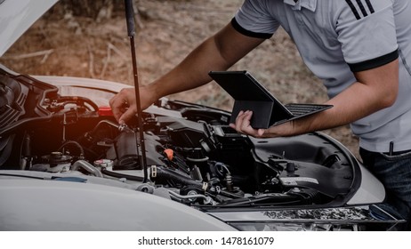 Check The Engine Room Of The Car Using A Computer.