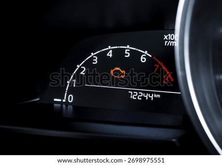 Check engine warning light on car dashboard, close-up of illuminated malfunction indicator symbol, vehicle diagnostics, car maintenance and engine problem alert concept