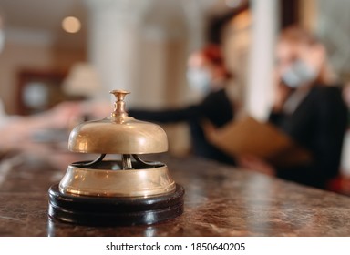 Check in hotel. receptionist at counter in hotel wearing medical masks as precaution against virus. Young woman on a business trip doing check-in at the hotel - Shutterstock ID 1850640205