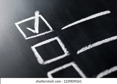 Check list on blackboard macro close up. Document of finished work duties and responsibilities. Agenda and progress in business. Checklist, keeping score of obligations or completed tasks in project. - Shutterstock ID 1229839261