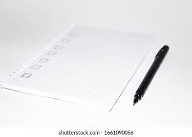 Check list. Square items are empty and checked with a tick. Squared notebook with black pen on a white background. Record ideas, notes, plans, tasks. Copy Space