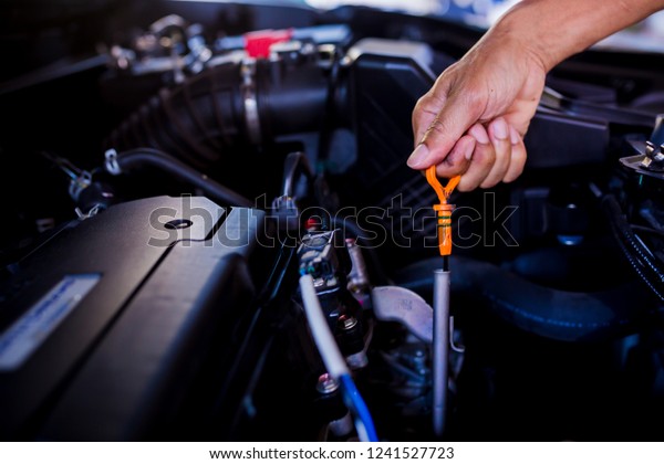 Check the oil level in car engine.
Mechanic checking car engine or vehicle. Check and maintenance car
with yourself. Service and maintenance
vehicle.