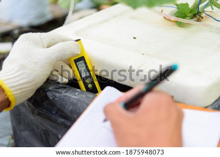 Check pH value of water bin of hydroponics system