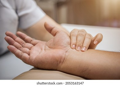 Check Pulse, Doctor's Hand Checks The Patient's Pulse With Traditional Chinese Medicine. Health Care Concept