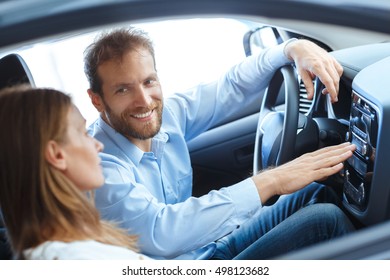 Check Put The Stereo System! Handsome Mature Man Smiling At His Wife Turning On Music While Sitting In Their New Car Together