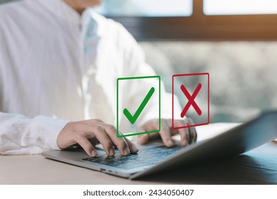 check right and wrong marks on a laptop. concept decide to choose vote. yes or no decisions, and business options for difficult situations in dilemma. true and false symbols agreeing
