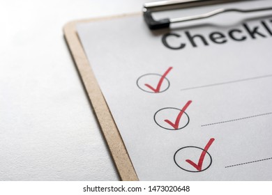 Checked Checklist On A Clipboard Is On A Bright Desk