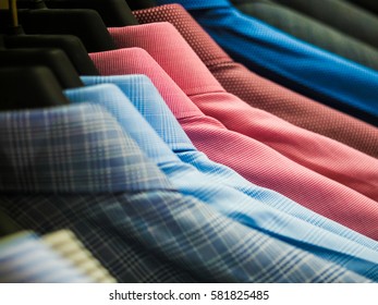 Checked men's shirts hanging on rack. - Powered by Shutterstock