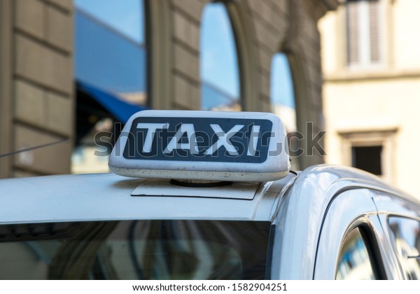 Checker\
taxi lighted rooftop car on a blurred\
background