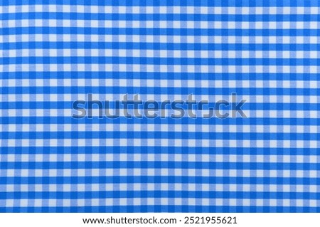Checkered blue fabric. Textile. Checkered fabric background with blue and white cells