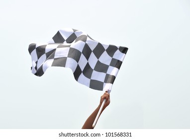 Checkered Race Flag In Hand.