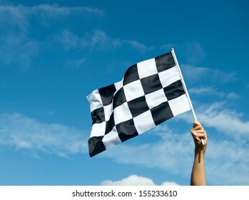 Checkered Race Flag In Hand.