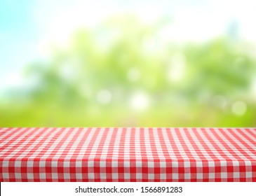 Checkered Red Picnic Table Cloth On Blurred Natural Background Wmpty Space.