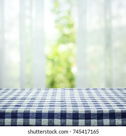 Checkered tablecloth texture top on blur of curtain with window view green from tree garden background.For montage product display or design key visual layout