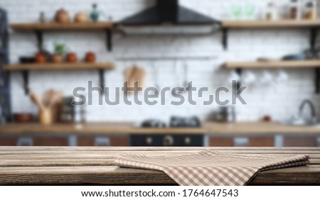Checkered towel on wooden table in kitchen. Space for text
