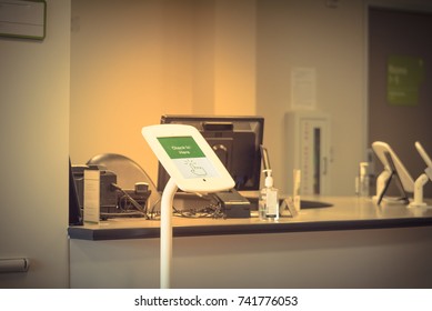 Check-in Kiosk Tablet Upon Arrival At Front Desk Of Test Center For Diagnostic Testing, Medical. Vintage Tone