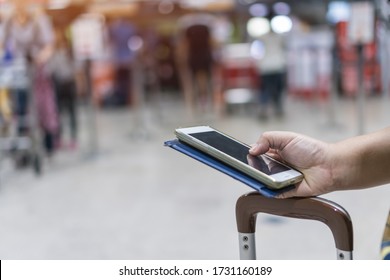 Checkin Online Or Booking By Smartphone Concept: Hands Using Smart Phone Apps In Airport ForCheck In Through Mobile Application, Traveler At Airport Departure Lounge Travel In Airplane 