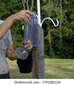 Checking The Amount Of Rainfall In A Rain Gauge