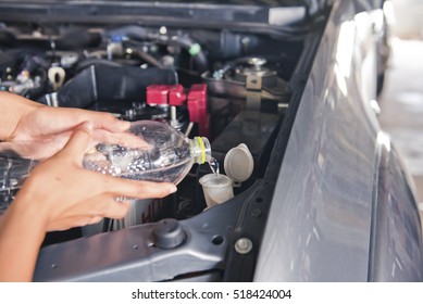 Checking Car Windshield Wiper Fluid And Fill The Windshield Washer Fluid Reservoir 
