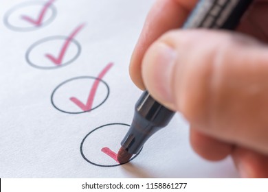 Checking completed tasks on a list - Shutterstock ID 1158861277