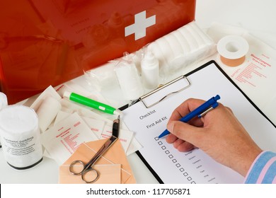 checking the content of a first aid kit - Powered by Shutterstock