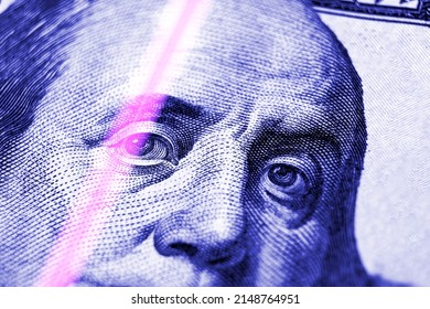 Checking Dollar Banknotes In A UV Light. Counterfeit Money Concept. Benjamin Franklin's Eyes From A Fragment Of New 100 Dollar