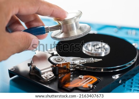 Checking hard drive with stethoscope. Hard drive repair and service concept.