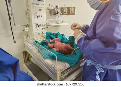 Checking health of newborn baby in hospital background