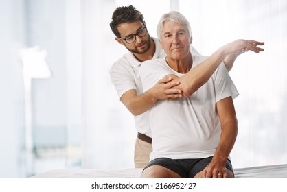 Checking His Range Of Motion. Cropped Shot Of A Young Male Physiotherapist Working With A Senior Male Patient.