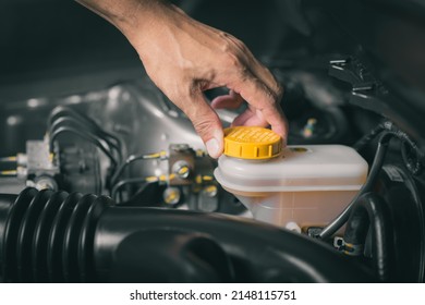 Checking the level of car's brake fluid. Car maintenance concept. - Shutterstock ID 2148115751
