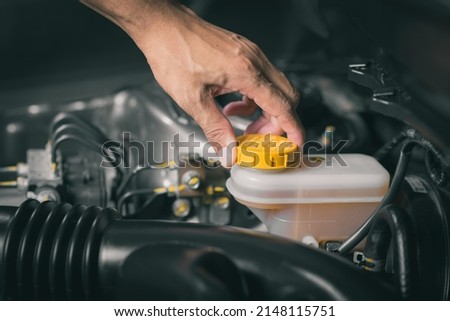 Checking the level of car's brake fluid. Car maintenance concept.