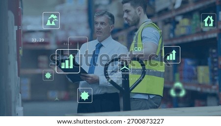 Checking manager white-shirt tie using tablet, operator hi-vis-vest moving pallet-jack in aisle, AR. Warehouse, industrial, collaboration, analytics, augmented, data, efficiency