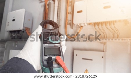 Checking and measuring solar panels using a multimeter, repairing power cable lines in solar panel inverters.