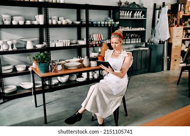 Checking my schedule for the day. Cropped shot of an attractive mature woman sitting alone and using a tablet in her pottery workshop. - Powered by Shutterstock