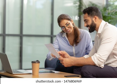 Checking Notes. Pleased Bearded Man Sitting In Semi Position While Working At Business Plan