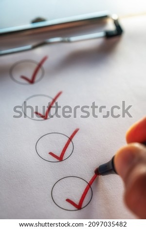 Checking off a to-do list on a clipboard with a red check mark