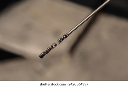 checking the oil level in the car engine. engine oil level dipstick. blurred background.