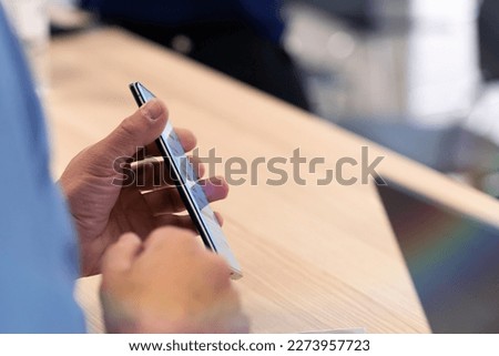 Checking in on a conference congress forum event, registration desk table, visitors and attendees receiving a name badge and entrance wristband bracelet and register electronic ticket