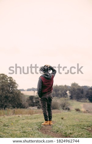 Similar – Image, Stock Photo Low angle view of blonde white girl posing in the forest with trees in the background.