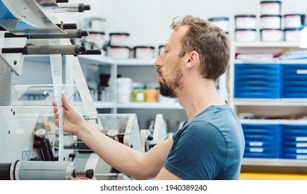 an checking quality of labels in printing shop